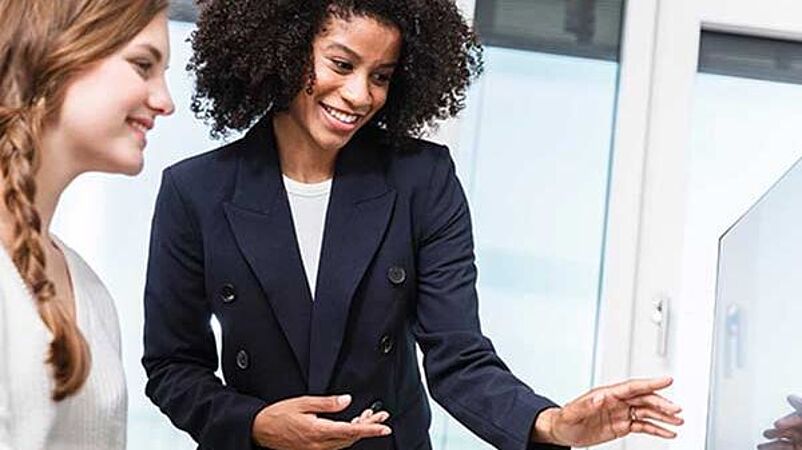 Apparel engineer and designer look at a screen